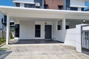 a white facade of a building with a driveway at Santai Villa di The Maris Desaru Coast in Bandar Penawar