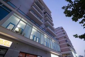 a building with glass windows on the side of it at Beliz Boutique Hotel in Vlorë