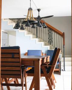 a dining room table with chairs and a staircase at Utopia in Palm Beach in Port Edward