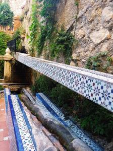 a bridge with blue and white tiles on the side of a mountain at Los Caños de La Casa Viva in Vélez Blanco