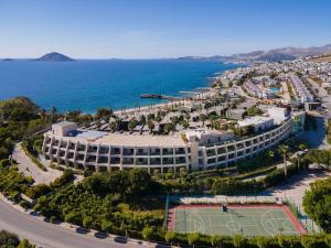 an aerial view of a resort with a tennis court at Swissôtel Resort Bodrum Beach in Turgutreis