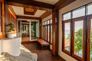 a living room with a view of the ocean at Dusit Buncha Koh Tao by Riya Group in Ko Tao
