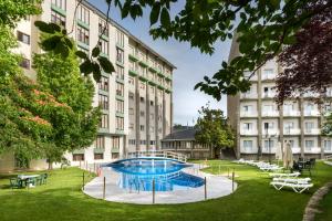 a pool in the courtyard of a building at Gran Hotel de Jaca in Jaca