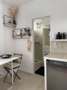 a kitchen with a counter and a table and a counter top at Gipsy Chic Duplex on the beach in Carolles