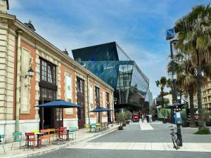 a street with tables and chairs and a building at Doubletree By Hilton Nice Centre Iconic in Nice