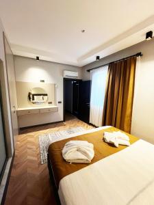 a hotel room with a bed with towels on it at Villa Zena Demre in Demre +12 photos