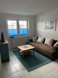 a living room with a couch and a coffee table at Am Ostseestrand in Zingst