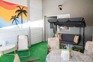 a porch with a bed and chairs and a table at 2k Cozy Beach House in Neoi Epivates