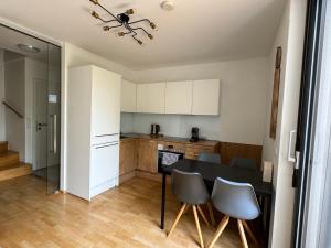 a kitchen with a table and chairs in a room at Cosy Splendor / City Center in Graz