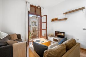 a living room with two couches and a table at Triana 2 in Melilla