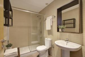 a bathroom with a toilet and a sink and a shower at Triana 2 in Melilla +8 photos