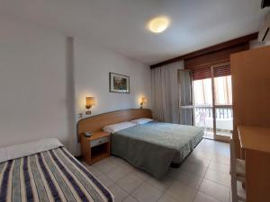 Postel nebo postele na pokoji v ubytování Hotel Nettuno