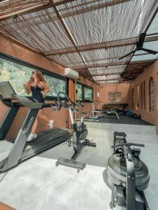 a woman running on a treadmill in a gym at Dracos Hotel in Parga