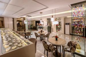 a restaurant with tables and chairs and christmas decorations at Atar Airport Hotel - Restaurant & Spa Wellness in Arnavutköy