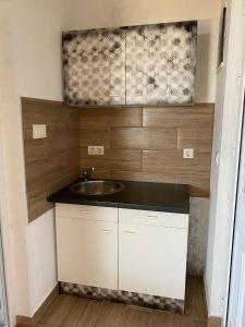 a small kitchen with a sink and a counter at White House in Sutomore