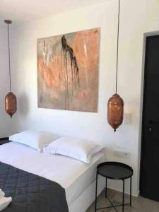 A bed or beds in a room at Mikri Sorriso - Luxurious Villa On The Beach