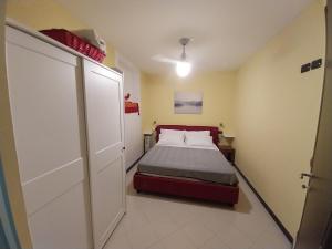 a small bedroom with a bed and a closet at IL FARO - garage mt 4,75 - beach mt 150 - 09001-LT-1414 in Alassio