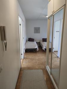 a room with a bed and a mirror at Saunallinen tilava kaksio keskustan ja rautatieaseman tuntumassa in Hämeenlinna