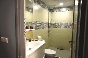 a bathroom with a sink and a toilet and a shower at Maison Nomedia in Essaouira