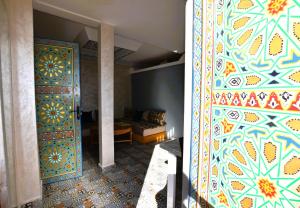 a room with a large door with a colorful patterned wall at Maison Nomedia in Essaouira