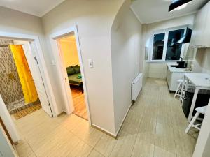a room with a hallway with a table and a kitchen at Next Studio Old Town in Constanţa
