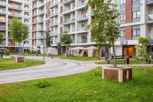 a winding road in front of a large apartment building at 6E, 142, 91m2, Tashkent City Park, Gardens Residence in Tashkent
