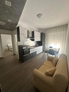 a living room with a couch and a table at LD Ianuzziello Residence - Jonica House in Scanzano +9 photos