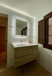 a bathroom with a sink and a mirror at Apartamento El rincón del Gato II in Santillana del Mar +5 photos