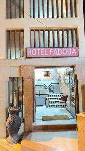 a hotel lobby with a hotel falahu sign and a vase at HOTEL FADOUA in Moulay Yacoub