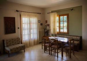 a dining room with a table and chairs at Litochoro House with a View in Litochoro
