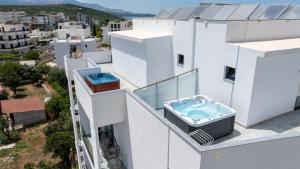 a balcony with a hot tub on a building at Duka's Hotel in Ksamil