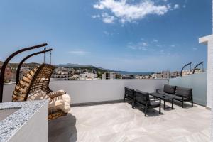 a balcony with a table and chairs and a view at Duka's Hotel in Ksamil