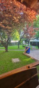 a park with a bench in a park with trees at Vila Valeria in Techirghiol