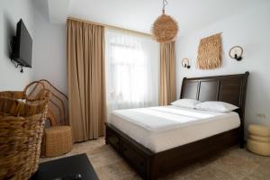 a bedroom with a large bed and a window at Vila Valeria in Techirghiol