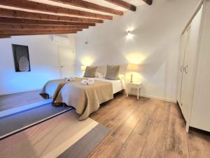 a bedroom with a bed with two candles on it at Casa Can Bernat in Santanyi +28 photos