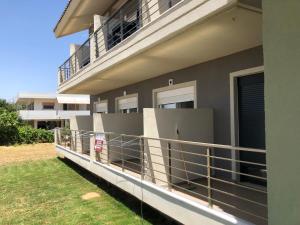 a balcony of a house with a fence at Alkyon Apartments Studios in Platanitis