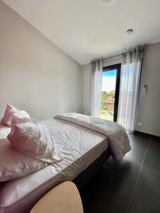 two twin beds in a room with a window at Auberge de Planzolles in Planzolles