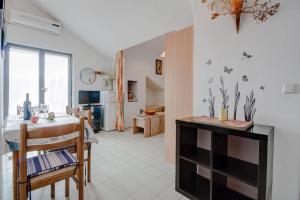 a kitchen and living room with a table and chairs at Apartment with beautiful view and big terrace in Vrboska
