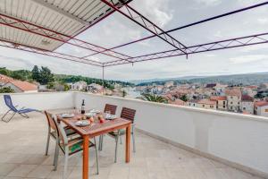 a table and chairs on a balcony with a view at Apartment with beautiful view and big terrace in Vrboska
