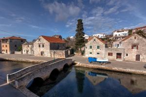 a bridge over a river in a town at Apartment with beautiful view and big terrace in Vrboska