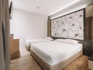 Postel nebo postele na pokoji v ubytování Hi Hotel Dot