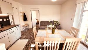 a kitchen and dining room with a table and chairs at Apartmány Hvězdecká in Broumov +13 photos