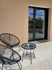 two chairs and a table on a patio at Auberge de Planzolles in Planzolles +10 photos