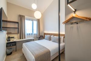 a hotel room with a bed and a desk at Hôtel Le Relais des Brasseurs - Aubagne in Aubagne