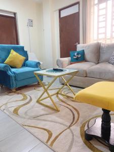 a living room with a couch and a table at Ravic Homes Nairobi,One bedroom in Nairobi