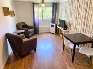 a living room with a table and chairs and a television at Lisbon Woods House in Lisbon