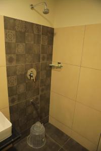 a bathroom with a shower with a toilet and a sink at KANS ONE - Hotel & Banquets in Chennai +117 photos