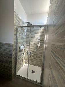 a shower with a glass door in a bathroom at LD Ianuzziello Residence - Jonica House in Scanzano