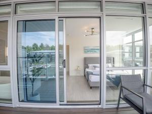 a room with sliding glass doors and a bedroom at Casa Lago 5 Bed Waterfront House in Innisfil +63 photos