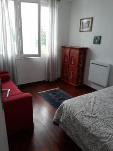 a bedroom with a bed and a dresser and a window at MAISON GRAND LUXE PROX. STVAAST LA HOUGUE-BARFLEUR in Saint-Pierre-Église